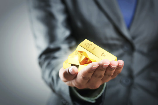Golden bars on the woman's hand