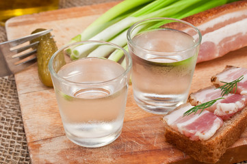 glass of vodka, cucumber and bacon