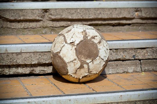 old soccer ball in the street