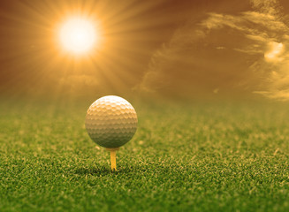 golf ball and tee on green grass