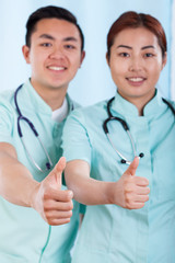 Couple of doctors with okay gesture