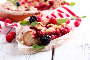Tasty cake with berries on table close-up