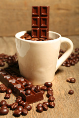 Cup with coffee beans and dark chocolate glaze