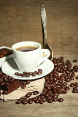 Cup of coffee and coffee beans with chocolate glaze