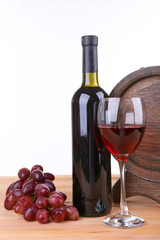 Obraz premium Wine in goblet and in bottle, grapes and barrel
