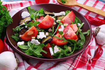 Eggplant salad with tomatoes, arugula and feta cheese,