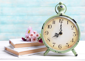 Beautiful flowers with clock and book