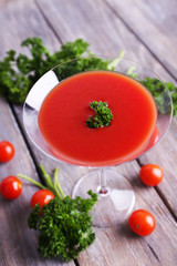 Tomato juice in goblet, parsley and fresh tomatoes