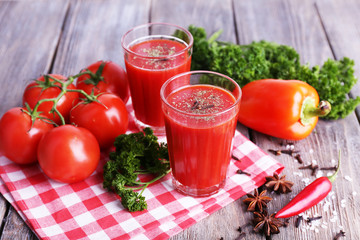 Tomato juice in glasses and fresh vegetables