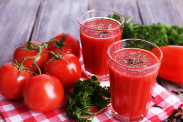 Tomato juice in glasses and fresh vegetables