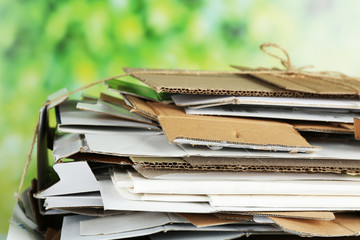 Big stack of papers on green background, close-up