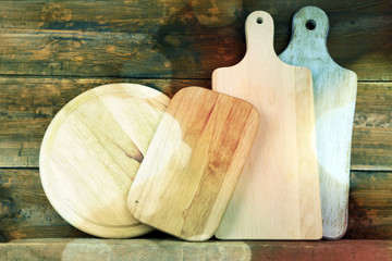 Empty cutting boards on wooden background