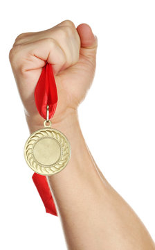 Golden Medal In Hand Isolated On White