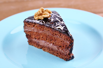 Delicious chocolate cake on plate on table close-up