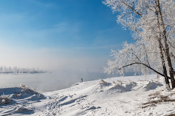 beautiful winter landscape with fisherman