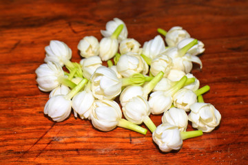 Group of white jasmine on wood