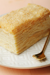 Napoleon cake on plate on table close-up