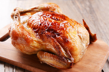 Delicious baked chicken on table close-up