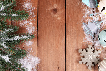 Green fir tree with toys and snow on wooden background