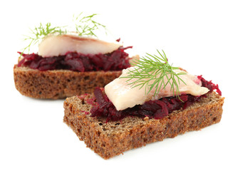 Canape herring with beets on rye toast, isolated on white