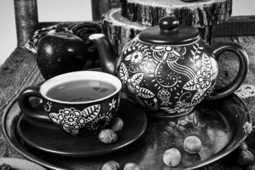 Tea cups with teapot on old wooden table