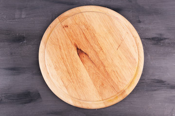 Empty cutting board on wooden background