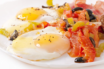Breakfast - fried eggs with bacon, tomatoes, olives and cheese