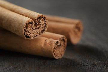 true cinnamon sticks on wooden table