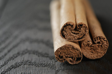 true cinnamon sticks on wooden table