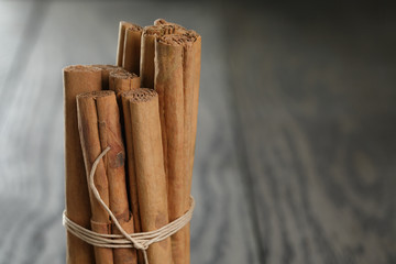 true cinnamon sticks on wooden table