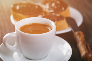 fresh espresso with baguette slices covered with chocolate cream