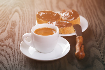 fresh espresso with baguette slices covered with chocolate cream