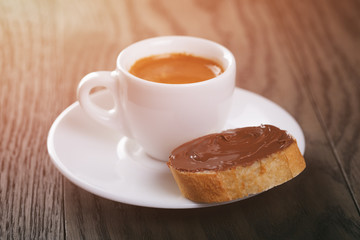 fresh espresso with baguette slice covered with chocolate cream