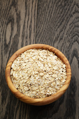 oat flakes in wood bowl on oak table