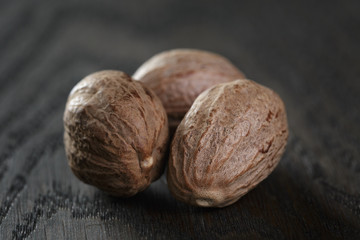 whole nutmegs on oak table