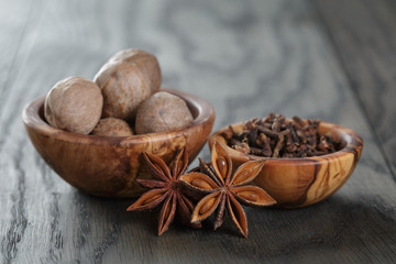 anise stars, cloves and nutmeg on oak table