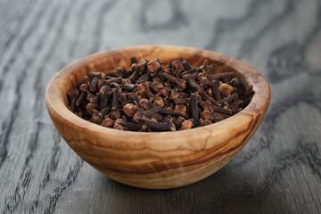 cloves in olive bowl on oak table