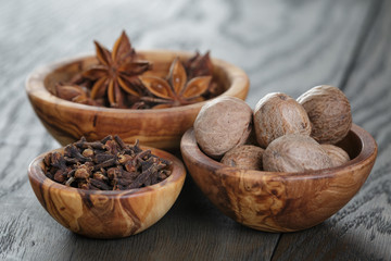 anise stars, cloves and nutmeg on oak table