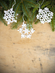 Christmas background with branches of fir and crochet stars