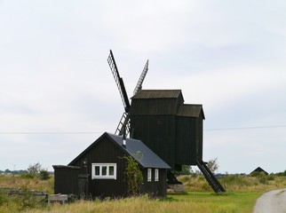 Fototapeta na wymiar A wooden wind mill on Oeland in Sweden