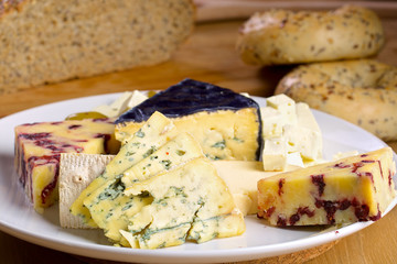 Various cheese and olives on a wooden board