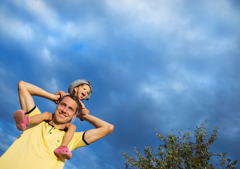 Father and daughter against the sky