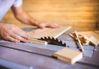 Handyman  cutting plywood on circular saw