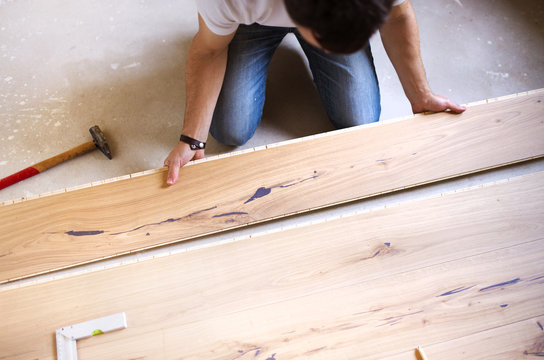 Handyman installing wooden floor