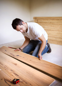 Handyman installing wooden floor
