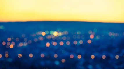 city blurring lights abstract circular bokeh blue background wit
