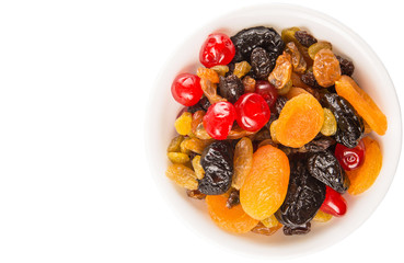 Mix variety of dried fruit in white bowl over white background