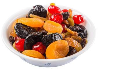 Mix variety of dried fruit in white bowl over white background