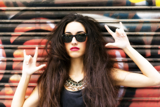 Beautiful woman portrait in rock style on urban background.