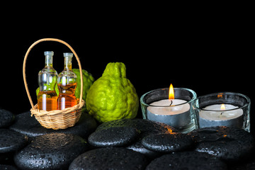 Obraz na płótnie Canvas Aromatic spa concept of bergamot fruits, candles and bottles ess